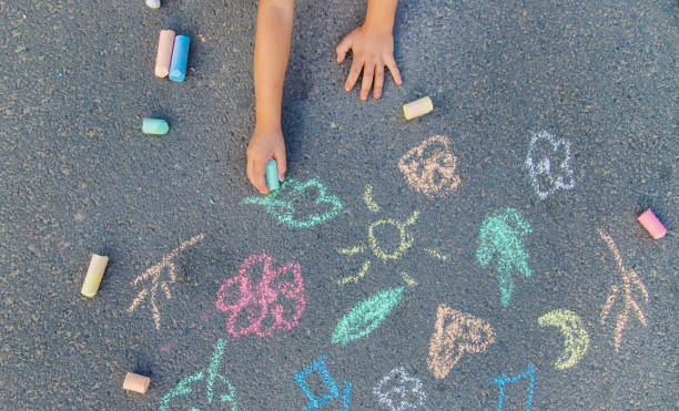 istock Children's drawings on the asphalt with chalk. Selective focus. 1183542060