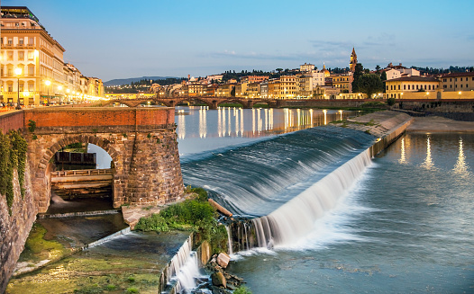 Evening mood on the weir Pescaia di Santa Rosa Arno in Florence Tuscany Italy
