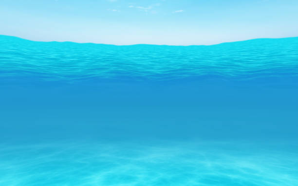 istock blue sky and blue ocean surface seen from underwater. 1183545645