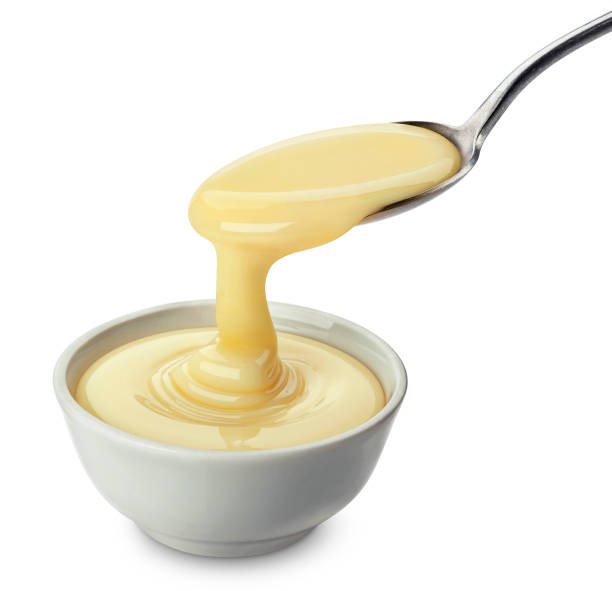 istock Pouring condensed milk isolated on white background 1183547762