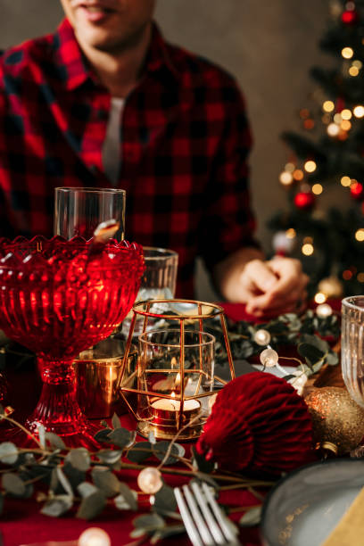 istock Man sitting by set christmas table 1183549160