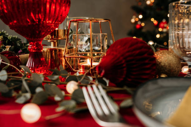 istock Christmas table with place setting Dining table with cutlery plate napkin and decorations for Christmas. 1183549167