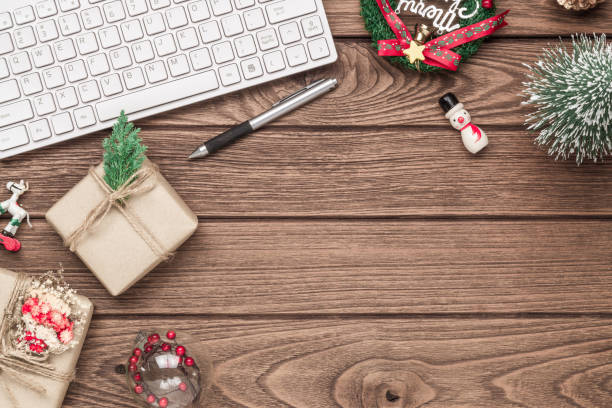 istock Merry Christmas and Happy new years office work space desktop concept. Flat lay top view with Computer keyboard, Gift boxes and Christmas ornaments with copy space. 1183550527