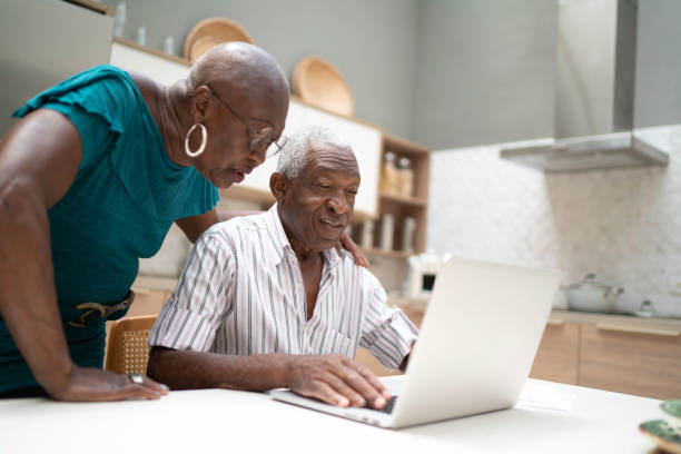 istock Senior couple using laptop at home 1183551460