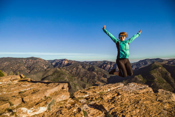 istock Jumping young girl in the mountain 1183556498