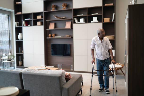 istock Senior man waking with a mobility walker at home 1183556665