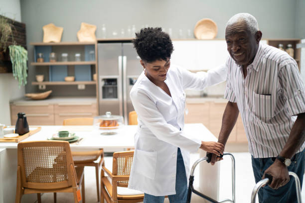 istock Caretaker assisting senior man with walker 1183558863