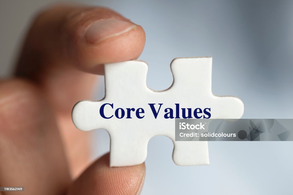 Core Values Man holding a jigsaw puzzle piece. Honesty Stock Photo