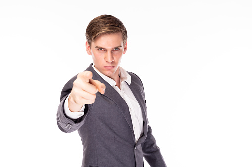 Studio shot of a handsome man pointing to copyspace against a gray background