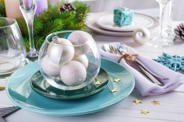 istock Place table setting for Christmas white table with blue and silver decor elements with green branches Christmas tree 1183563015