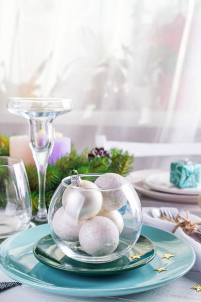 istock Place table setting for Christmas white table with blue and silver decor elements with green branches Christmas tree 1183563720