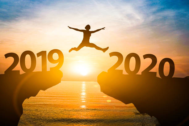 Man jump from year 2019 to 2020. Starting of new year concept. Man jump from year 2019 to 2020. Starting of new year concept. 2019 photos stock pictures, royalty-free photos & images