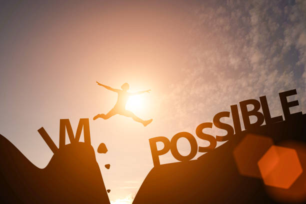 istock Man jump between impossible wording and possible wording on mountain. Mindset for career growth business. 1183564073