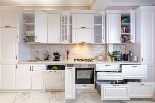 istock Luxury modern white kitchen interior with open doors and drawers 1183564834