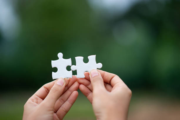 istock Hands and puzzles, important pieces of teamwork Teamwork concept 1183568759