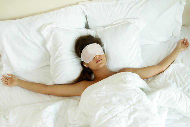istock Woman is wearing eye mask and using earplugs 1183568779