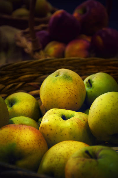 Fresh, organic apples in the punnet on the table; close up