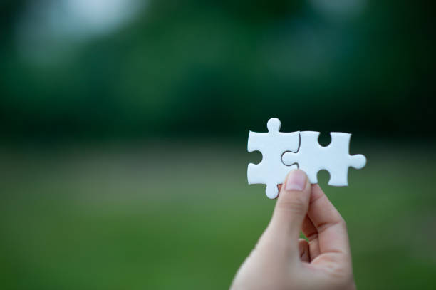 istock Hands and puzzles, important pieces of teamwork Teamwork concept 1183569209