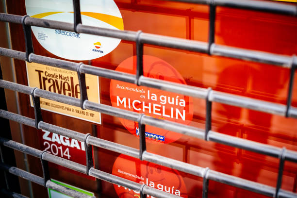 Michelin Conde Nast Traveler, Repsol selection restaurants guide Barcelona, Spain - Nov 14, 2017: Recomendado en la guia Michelin Conde Nast Traveler, Repsol selection - closed sticker by guides on the facade of closed restaurant book title stock pictures, royalty-free photos & images