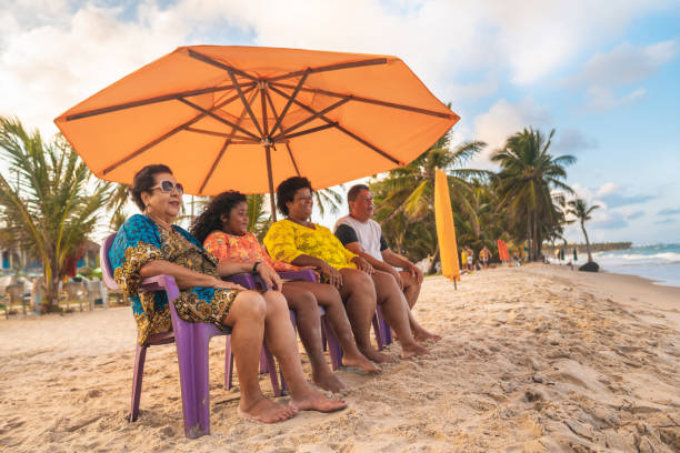 Tourists on the beach under a tent