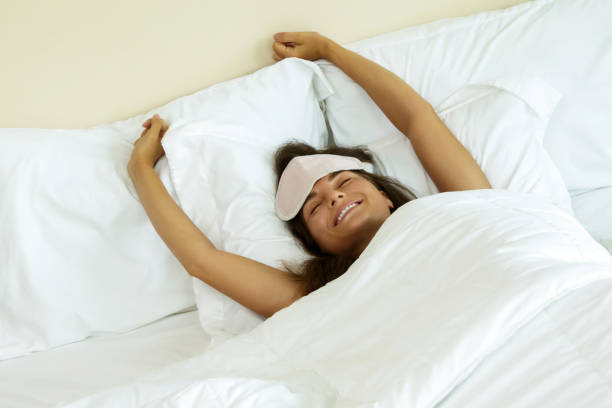 istock Happy woman waking up after good sleeping 1183571377