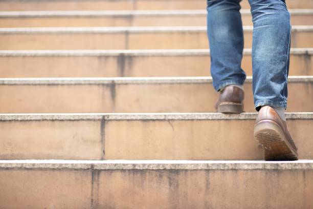 The image of a man walking up the stairs stock photo