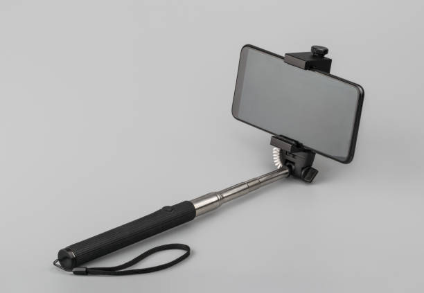 istock selfie stick with phone on grey background 1183573850