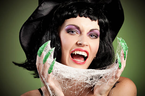 halloween mujer cara bruja vampiro con sus uñas verde - studio shot mouth open horizontal head and shoulders fotografías e imágenes de stock