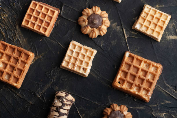 istock flat lay image of the wafer on the dark table, pattern cookies, 1183575336
