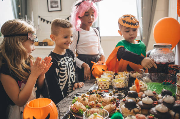 istock Kids eating on Halloween party 1183576540