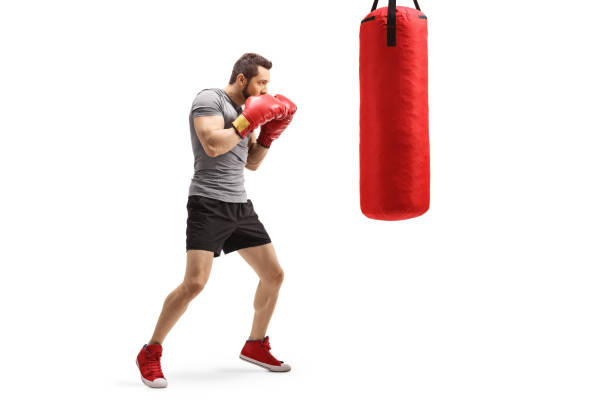 istock Young fit man training box with a punching bag 1183577563