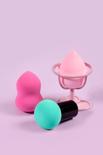 istock Pastel group of make-up foundation blender sponge on purple background 1183578611