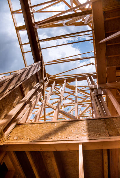 istock New construction home framing against a blue sky 1183579203