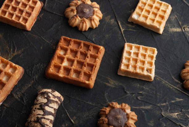 istock flat lay image of the wafer on the dark table, pattern cookies, 1183581946