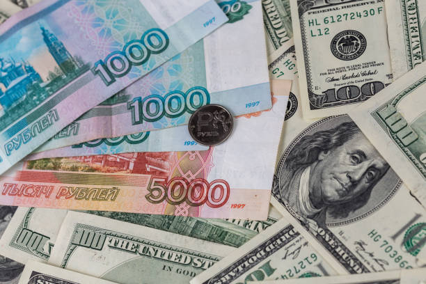 istock us dollars and russian rubles close-up background with selective focus 1183586271
