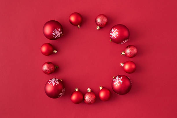 istock Flat lay frame with red christmas balls on a red background 1183586364