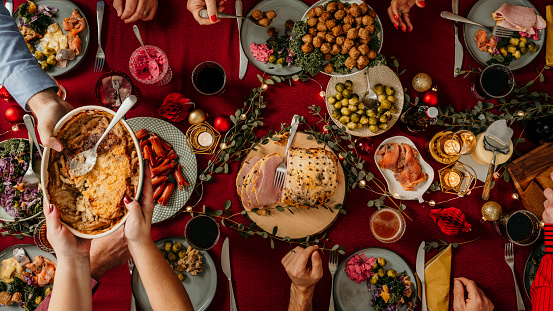 Typical swedish scandinavian christmas smörgåsbord buffet food Photo taken from above overhead table top shot Photot of typical smorgasbord with breaded ham, meatballs, sausauge,noisette, pickled herring and side dishes Julbord med griljerad skinka sill och lax