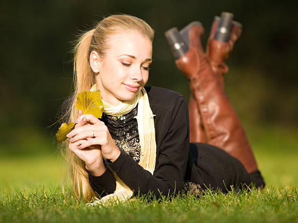 Young smiling woman day dreaming while relaxing in autumn day in forest. Copy space. Photographed in medium format.