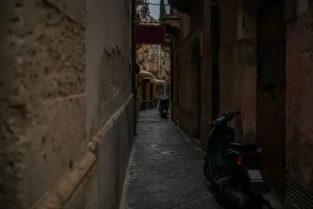 Empty narrow typical for Italy street with two motorbikes