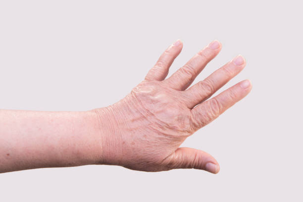 istock High angle view of senior woman's hand over gray background 1183591462