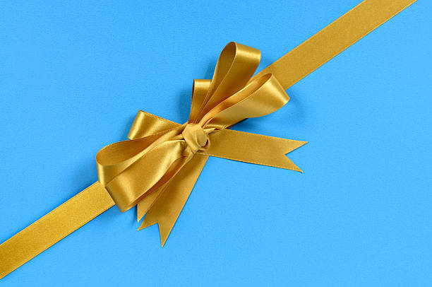istock Gold gift ribbon on blue 118359168
