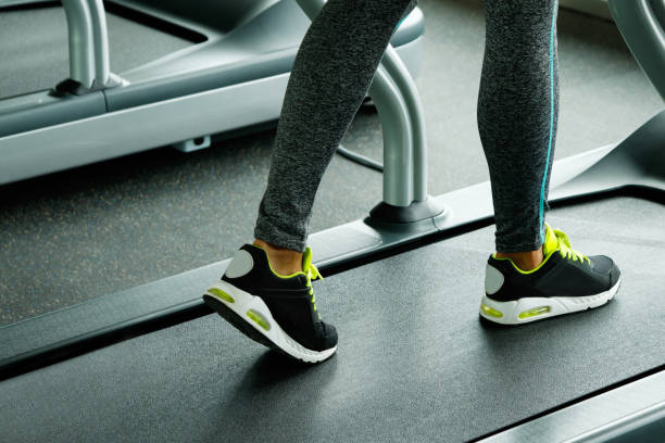 istock Female legs and treadmill 1183595879
