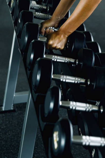 istock Dumbbells and female hands 1183595906