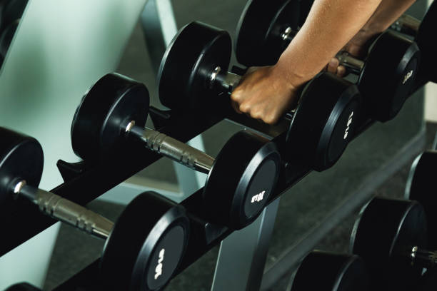 istock Dumbbells and female hands 1183595944