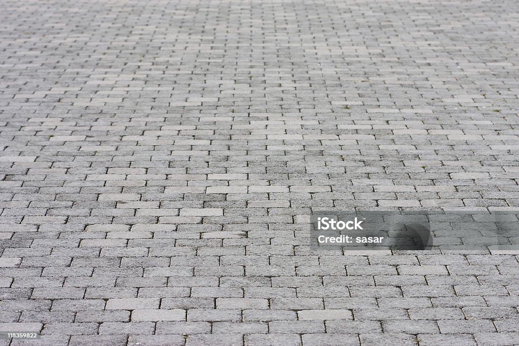 Standard pavement made up of rows of grey bricks Brick pavement footpath background. Brick Stock Photo