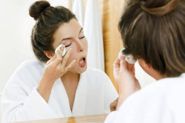 istock Woman removing makeup with a cotton pad 1183599917