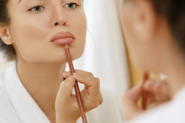 Woman drawing lip contour stock photo