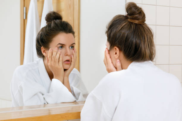 istock Tired woman is looking into the mirror 1183601691