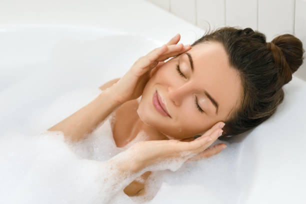 istock Beautiful young woman taking bath 1183602538