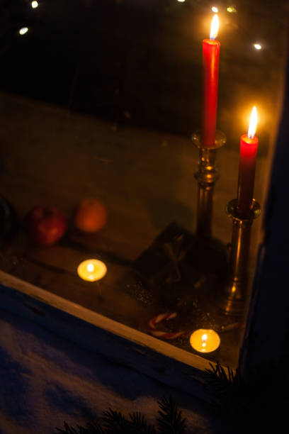 istock Looking into a Christmas window with burning candles in winter 1183603039
